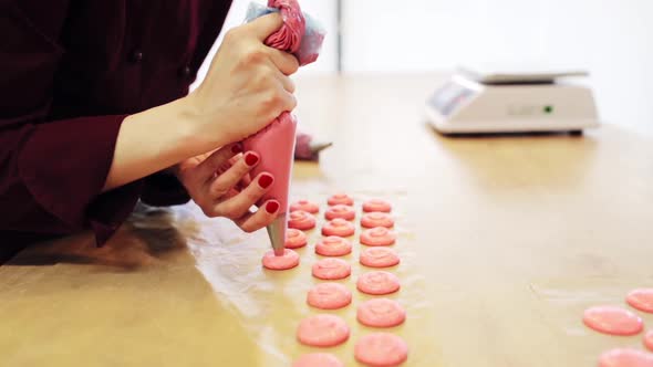 Chef with Injector Squeezing Macaron Batter