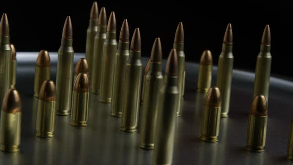 Cinematic rotating shot of bullets on a metallic surface - BULLETS