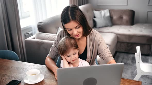 Young Mother Explaining and Teaching Computer Pc to Female Kid