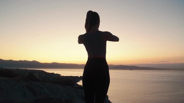Silhouette of Woman Practices Yoga and Doing Stretching at Sunrise, Slow Motion