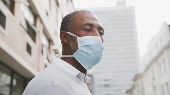 African american man on the go wearing coronavirus covid19 mask