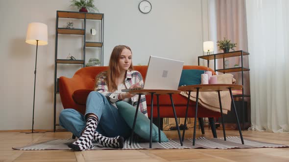 Cheerful Young Woman Sitting on Floor Using Laptop Pc Share Messages on Social Media Application