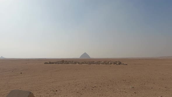 Establishing shot of Egyptian desert with Bent Pyramid in horizon, Dahshur. Egypt
