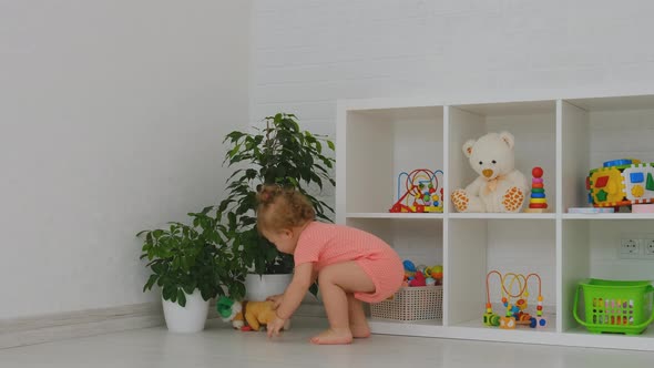 The Child is Playing with Toys in the Room