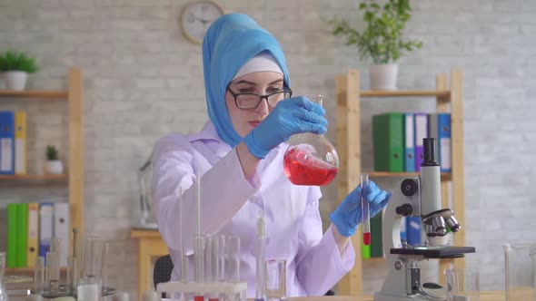 Muslim Woman Scientist Chemist in National Scarf Working in the Lab Close Up Slow Mo