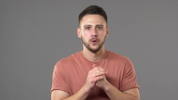 Portrait of Tense Concentrated Man Wearing Casual Clothing Screaming in Triumph and Clenching Fists