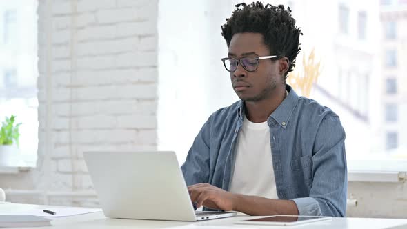 Young African Man Leaving the Working Desk 