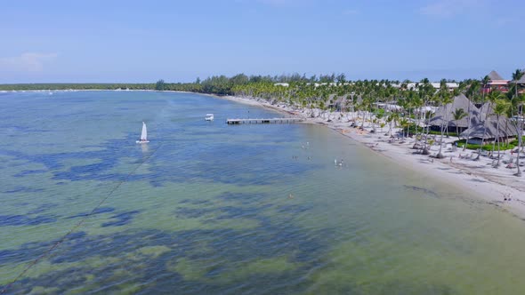 Drone flying over Bavaro beach and jetty, Punta Cana in Dominican Republic. Aerial forward