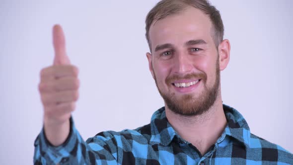 Face of Happy Bearded Hipster Man Giving Thumbs Up