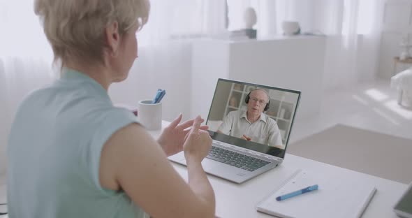 Man and Woman Are Communicating Online By Video Chat at Laptop, Spouses From Different Cities Are