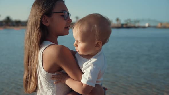 Adorable Children Enjoying Sunny Morning at Beautiful Seashore at Sunrise.