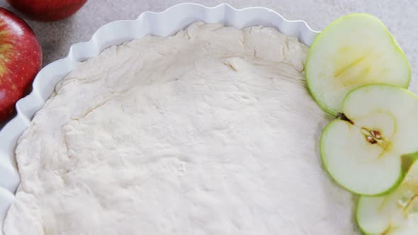 Raw tart with slice apple on table 4k