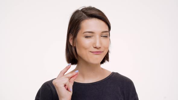 Portrait of Young Pretty Girl Clicking Finger and Winking