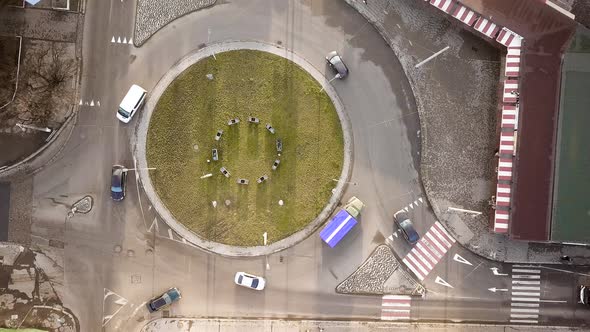 Top down aerial view of city traffic with cars moving on a street at roads intersection.