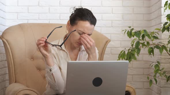 Lady freelancer eye fatigue at home office. 