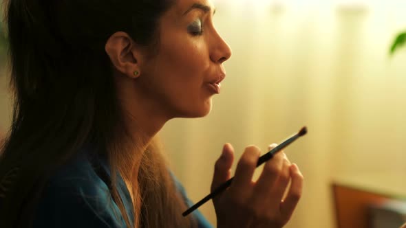 Woman Using Makeup Brush at Home 4k