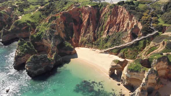 Secluded sand beach surrounded by cliffs, Lagos , Algarve.  Long wooden walkway access.