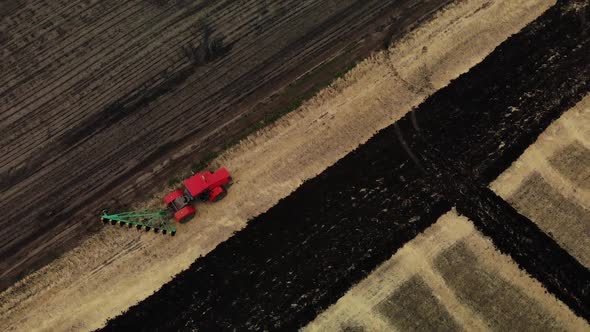 Tractor Plowing Fields, Preparing Land for Sowing. Aerial Spin View. Farmer in Tractor Preparing