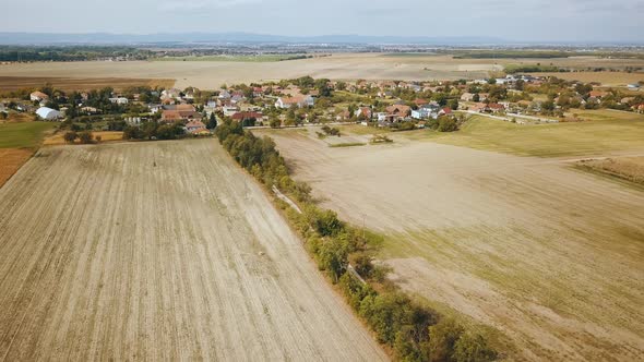 Drone shot over field and village houses