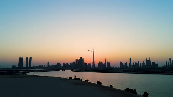 Aerial view of drone filming Dubai cityscape during scenic sunset, U.A.E.