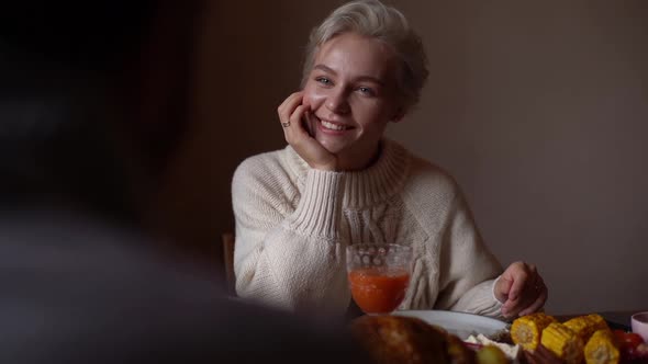 Closeup View From Back to Happy Young Woman in Love Smiling While Listening to Unrecognizable Man