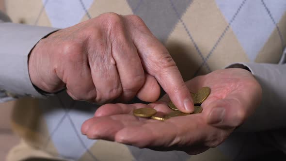 Senior Male Counting Euro Cents in Hand Closeup, Pension Insurance, Poverty