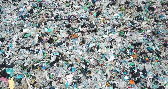 Piles of Garbage Plastic and Glass Bottles Scattered on the Ground in Plastic Bags