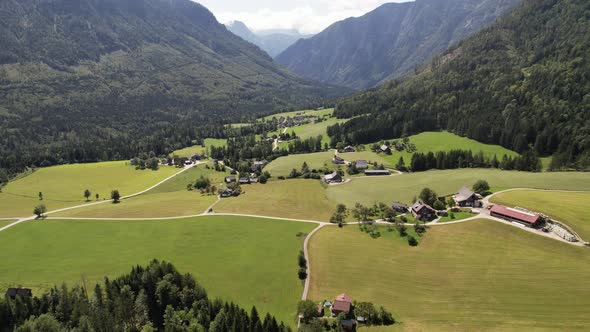 Aerial view of the village, fields and forest in mountains Alps Austria