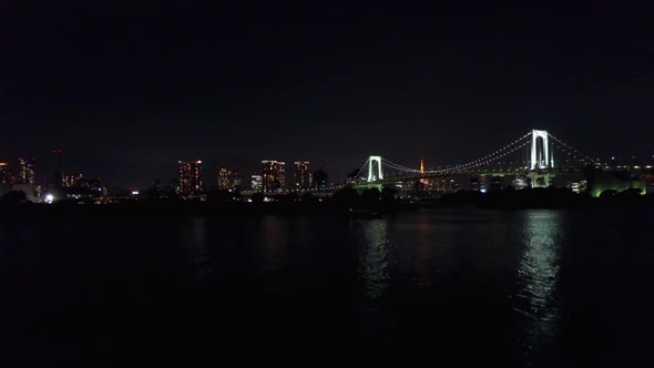 Rising on rainbow bridge at night time over water