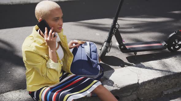 Mixed race woman on the phone on the street