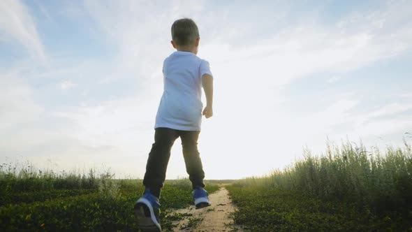 Cheerful Kid on the Road at Sunset