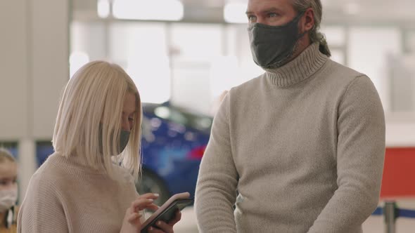 Adult Couple With Luggage At Check-In