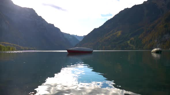 Red and white boat in a beautiful artificial lake in Switzerland.