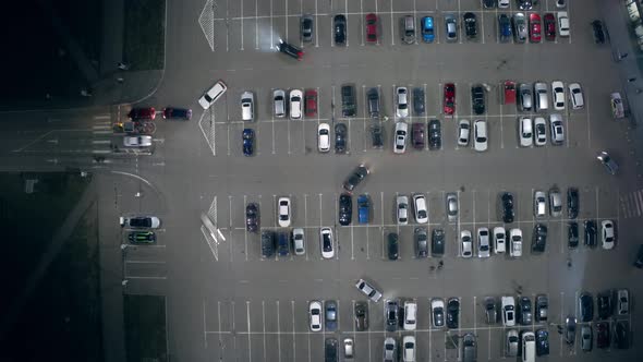 A Timelapse Car Traffic on a Big Parking Lot Near the Supermarket at Night