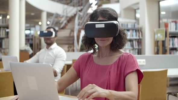 Front View of Cheerful Caucasian Woman Wearing VR Headset