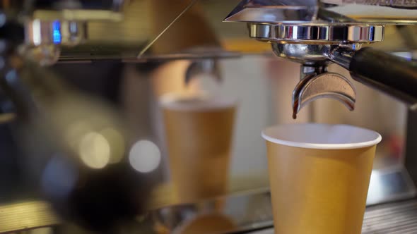 Fresh Espresso Coffee Dripping From Double Holder Into Disposable Paper Cup in Professional Coffee