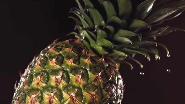 Super Slow Motion Water Drips on Rotating Pineapple