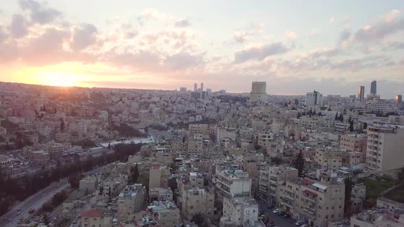 Beautiful and peaceful skyline of aerial drone clip of sun rising over the city of Amman Jordan