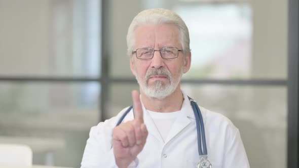 Portrait of Senior Old Doctor Showing No Sign By Finger