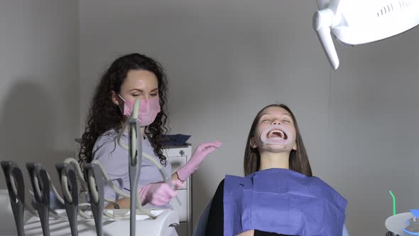 Professional dentist examine and treat spoiled teeth