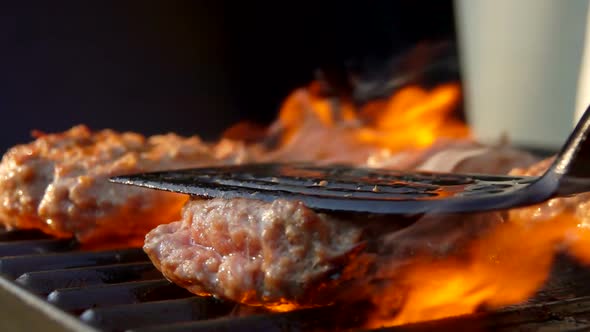 Burgers Is Pressed By Kitchen Spatula To the Grill