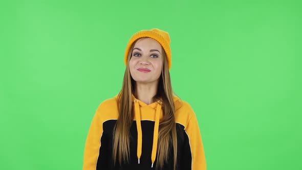 Portrait of Modern Girl in Yellow Hat in Anticipation of Worries, Then Disappointed and Upset. Green