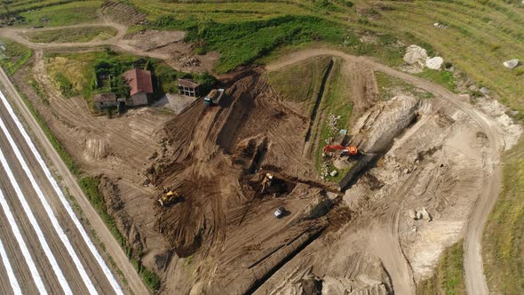 Trucks and Excavators Working on Farm