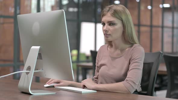 Working Woman Saying No with Finger While Working on Desktop
