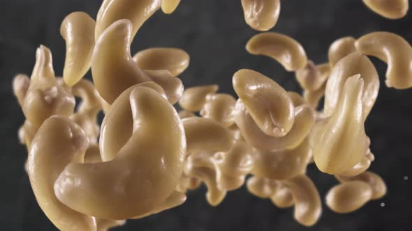 Flying of Cashews in Dark Kitchen Background