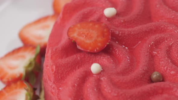 Close Up of a Pink Strawberry Cake Swirling on a White Plate