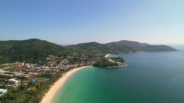 beautiful sunny summer tropical day at Karon beach with many hotels and resorts and turquoise blue w