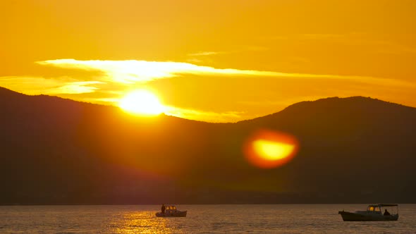 Motorboats floating on the sea at sunset