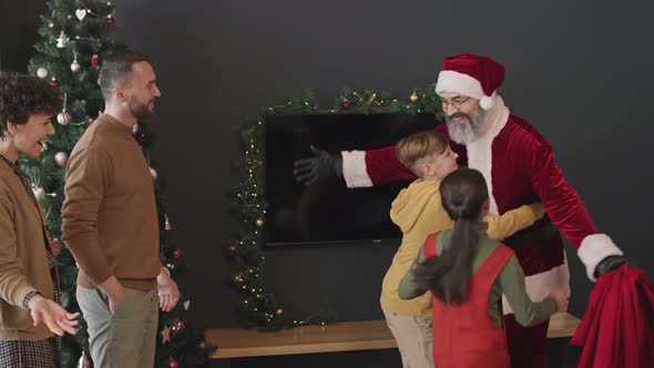 Kids Meeting Santa with Presents at Home