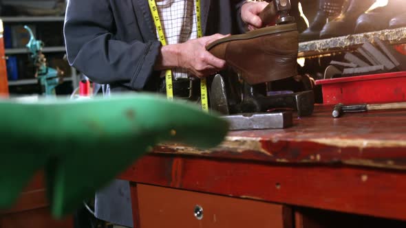 Shoemaker hammering on a shoe